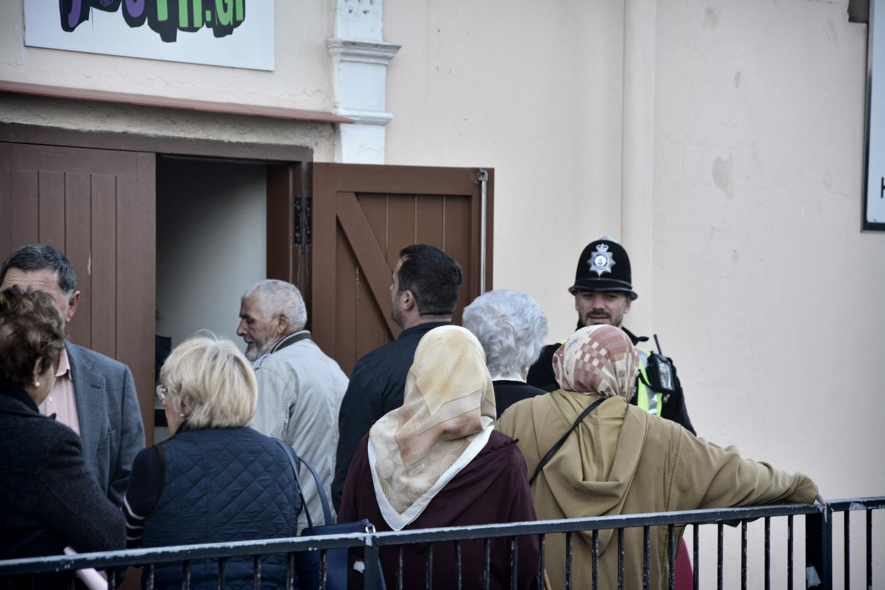 Gibraltar - 26th November 2015 - (Line Wall Road Polling station where tensions were high at one point this morning) - Police were today requested to make their presence known at the polling station by Line Wall Road after GSD activists handing leaflets outside the polling station are alleged to have made complaints over the use of the language used by a GSLP/Liberal activist handing leaflets to voters of Moroccan origins.According to reports received by Core Photography the GSD activists complained that the use of the native Moroccan language should not be allowed by those guiding voters outside the polling station, claiming the "official language in Gibraltar is English," according to witnesses present during the incident. This resulted in  tensions between the activists. Police were present to calm down the situation which has been played down as a minor incident. Executive members of the GSD approached over the incident have indicated that they were not at the time aware of such an incident, but have indicated that they would not support such actions and would be looking into the matter.No further known incidents have been reported throughout the day.Voting has been steady throughout the day, with politicians attending the polling stations throughout the morning as voters queue up to vote.The Commissioner of Police has attended polling stations to oversee security in person.